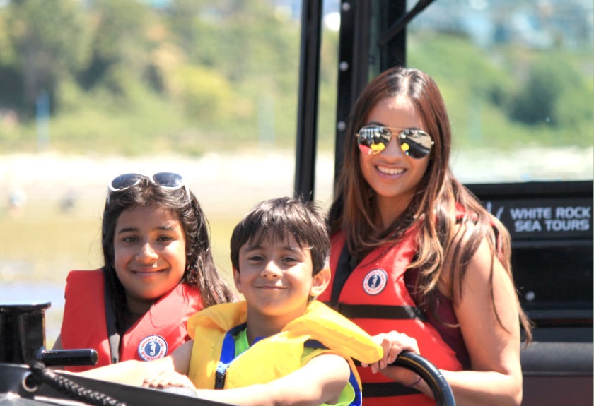 a little girl sitting on a boat
