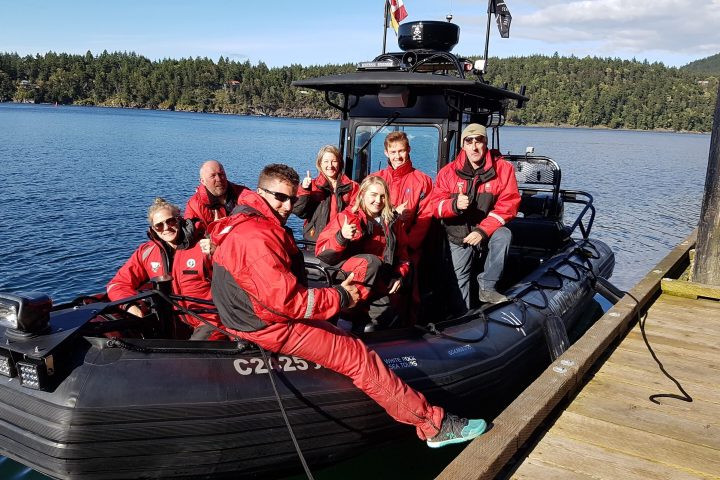 a group of people sitting in a boat on a body of water