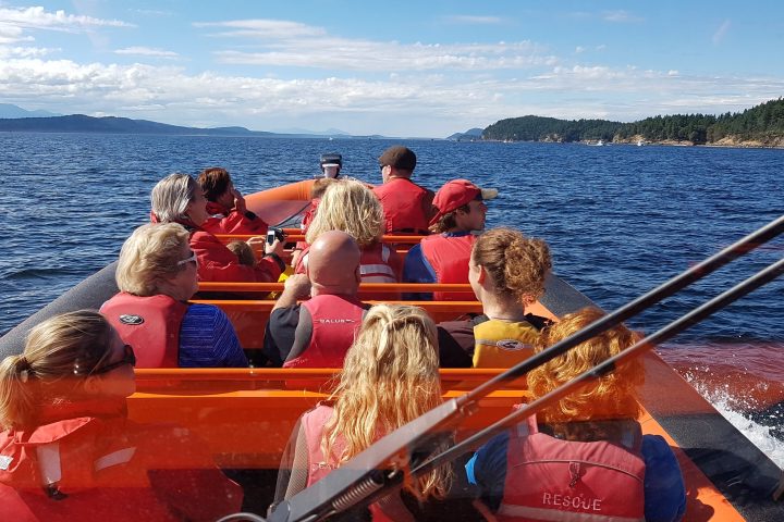 a group of people in a boat on a body of water