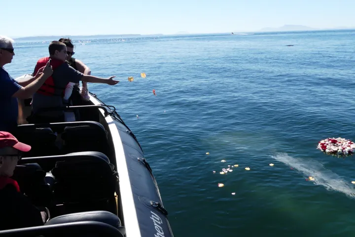 a group of people in a boat on a body of water